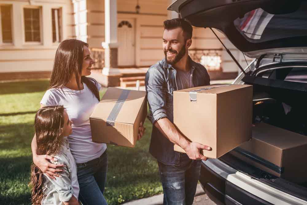 Happy,Family,Is,Standing,Near,Car,With,Cardboard,Boxes.,Moving